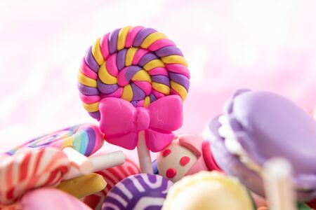 Toys. Spiral lollipop and different colored round candy. Candy backgroundの写真素材