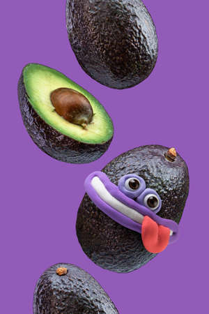 Sliced and whole avocado in flight on a bright backgroundの写真素材