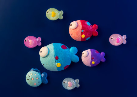 School of decorative fish on the dark blue backgroundの写真素材