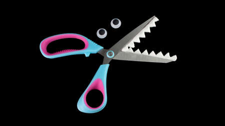 Sharp-toothed scissors. Scissors with eyesの写真素材