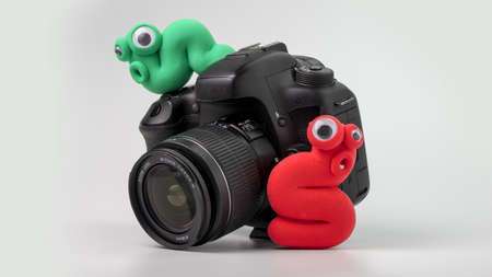 Plasticine worms on the cameraの写真素材