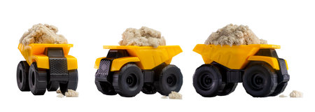Three toy dump trucks loaded with kinetic sand.の写真素材