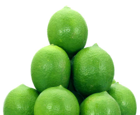Stack of green lemon fruits isolated on white background. An example source of vitamin C.の写真素材