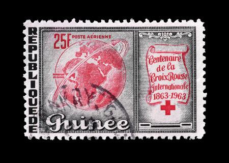 GUINEA - CIRCA 1963 : Postage stamp printed by Guinea, that shows Globe Encircled by Satellite.のeditorial素材