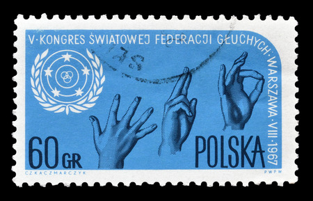 Cancelled postage stamp printed by Poland in 1967, that shows Sign language and emblem, honoring  5th Congress of the World Federation of the deaf  in Warsaw.のeditorial素材