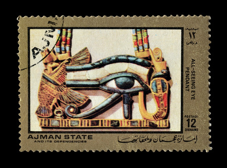 Cancelled postage stamp printed by Ajman state, that shows All seeing eye pendant, circa 1972.のeditorial素材