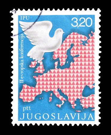 Cancelled postage stamp printed by Yugoslavia, that shows map of Europe and dove, circa 1975.のeditorial素材