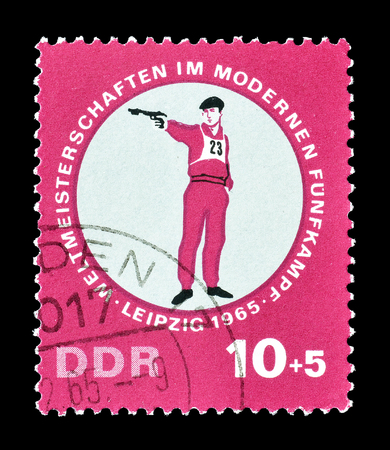 Cancelled postage stamp printed by German Democratic Republic, that shows Pistol shooting, circa 1965.のeditorial素材