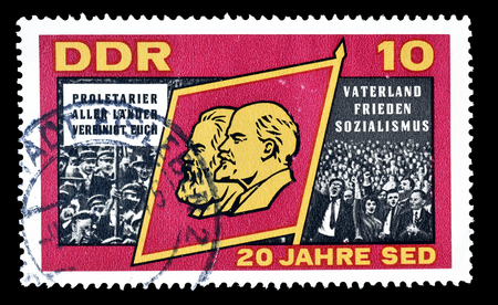 Cancelled postage stamp printed by German Democratic Republic, that shows  Marx, Lenin and crowd, circa 1966.のeditorial素材