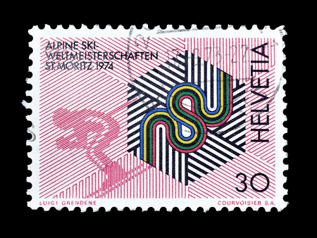 Cancelled postage stamp printed by Switzerland, that shows Badge of the championships and downhill skier, circa 1973.のeditorial素材