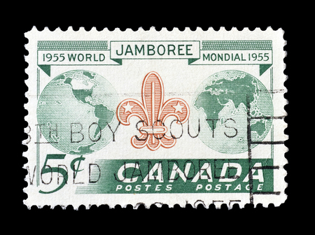 Cancelled postage stamp printed by Canada, that shows Scout badge and globe, circa 1955.のeditorial素材