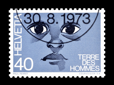 Cancelled postage stamp printed by Switzerland, that shows Face of the child, circa 1973.