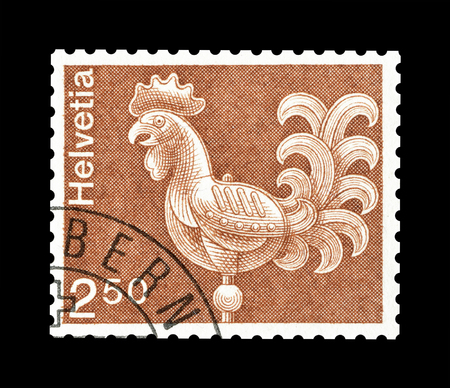 Cancelled postage stamp printed by Switzerland, that shows rooster, circa 1975.のeditorial素材