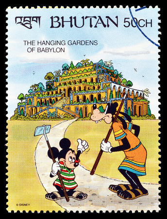 Cancelled postage stamp printed by Bhutan, that shows Mickey Mouse and Goofy visiting Hanging gardens of Babylon, circa 1991.のeditorial素材