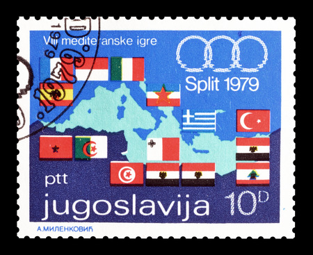 Cancelled postage stamp printed by Yugoslavia, that shows Mediterranean games logo, map of Europa and flags, circa 1979.のeditorial素材