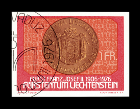 Cancelled postage stamp printed by Liechtenstein, that shows Old coin, circa 1976.のeditorial素材