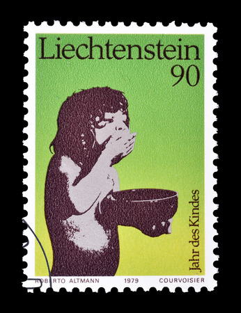 Cancelled postage stamp printed by Liechtenstein, that shows Child eating, circa 1979.のeditorial素材