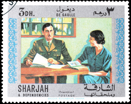 Cancelled postage stamp printed by Sharjah, that shows General de Gaulle and a Lady, circa 1970.のeditorial素材