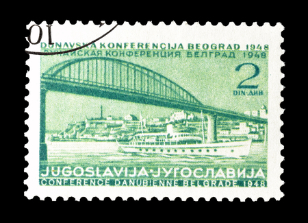Cancelled postage stamp printed by Yugoslavia, that shows Bridge and ship, circa 1948.のeditorial素材