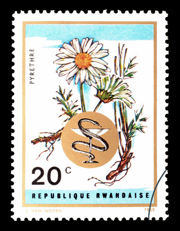 Cancelled postage stamp printed by Rwanda, that shows  Camomile, circa 1969.のeditorial素材