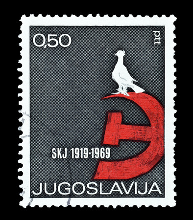 Cancelled postage stamp printed by Yugoslavia, that shows Hammer and sickle with peace dove, circa 1969.のeditorial素材