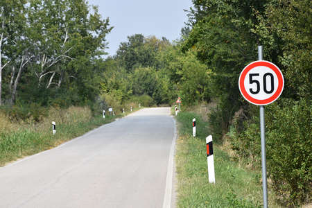 Road sign that warns the drivers that maximum speed is 50 kilometres per hour
