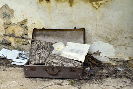 Vintage suitcase filled with rubbish