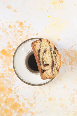 A piece of babka on a cup. White background.の写真素材