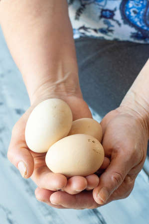 A woman holding several eggsの写真素材