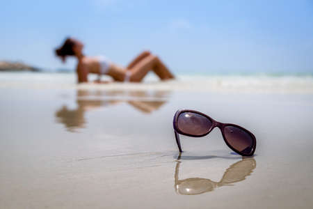 Sunglasses in the sea stick out of the water.の写真素材