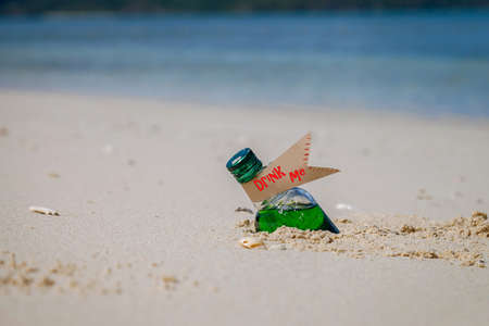 magic drink in a bottle on the beach in the sandの写真素材