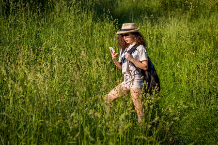 Girl with a backpack in the field.の写真素材