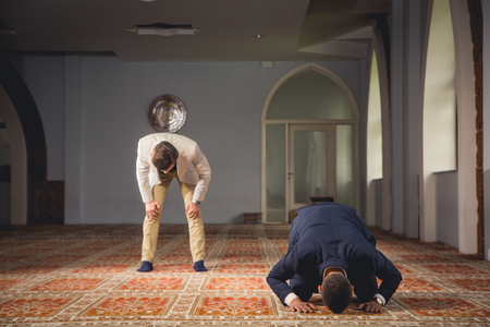 Young Muslim men praying in a mosque.の写真素材