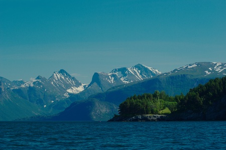 The Romsdalsfjorden close to Andalsnes in Norway in summer with green trees and snow on the top of the mountainsの写真素材