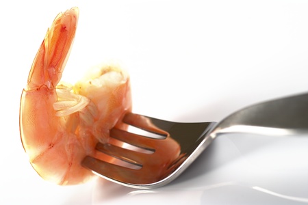 Cooked king prawn on fork (Selective Focus, Focus on the tail) の写真素材