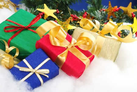 Colorful christmas presents with christmas decoration on cotton (Selective Focus, Focus on the blue...