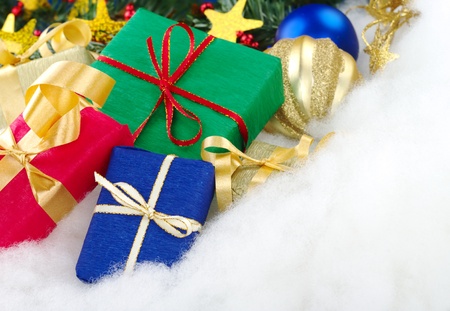 Colorful christmas presents with christmas decoration on cotton (Selective Focus, Focus on the blue...