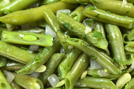 Cooked green beans (bush beans) with onions and parsley (Selective Focus, Focus on the parallel bean tops in the upper right third, and the bean top in the left bottom corner)の写真素材