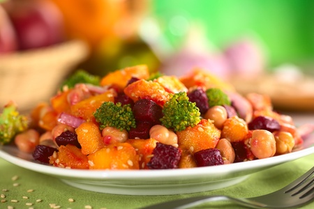 Pumpkin, beetroot, broccoli and chickpea salad garnished with sesame seeds (Selective Focus, Focus on the two broccoli florets in the front and the vegetable around) の写真素材