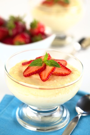 Semolina pudding with strawberry slices and mint (Selective Focus, Focus on the mint leaf)の写真素材