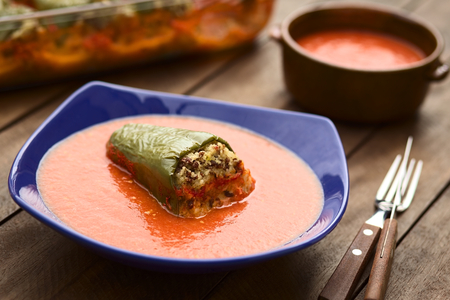 Hungarian baked pepper filled with mincemeat and rice eaten with tomato sauce  Selective Focus, Focus on the front edge of the filled pepper の写真素材