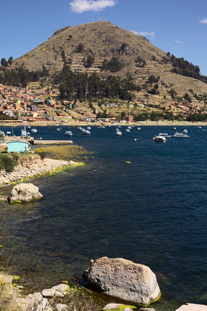 COPACABANA, BOLIVIA - OCTOBER 17, 2014: Motor boats anchoring in the bay of the small tourist town on the shore of Lake Titicaca on October 17, 2014 in Copacabana, Bolivia. Copacabana is the starting point for tours and transportation to Isla del Sol (Sunのeditorial素材