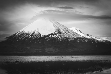 Parinacota stratovolcano (6348 meters) and Chungara Lake on the border of Chile and Bolivia on the way from La Paz to Arica. Parinacota is part of the Payachata volcanic group in Northern Chile. (Monochrome Image)の写真素材
