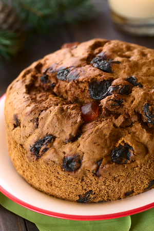 Traditional Chilean Pan de Pascua Christmas Cake made with spices, dried fruits and raisins, photographed with natural light (Selective Focus, Focus one third into the cake)の写真素材