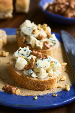 Blue cheese and walnut canapes, photographed with natural light (Selective Focus, Focus on the front of the first canape)の写真素材