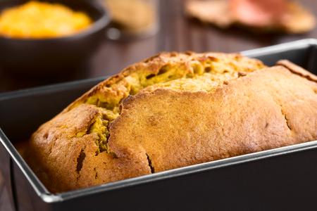 Fresh homemade pumpkin bread in pan (Selective Focus, Focus one third into the bread)の写真素材