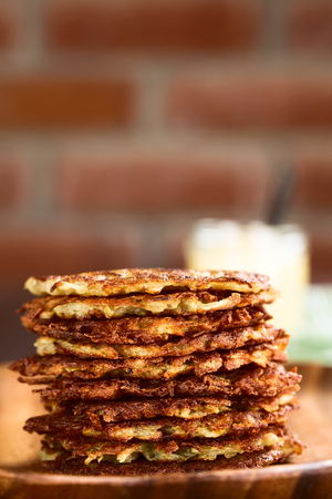 Fresh homemade thin potato fritters or pancakes in a pile, a traditional German snack or dish called...