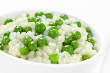 Fresh homemade creamy green pea risotto in bowl (Selective Focus, Focus in the middle of the image)の写真素材