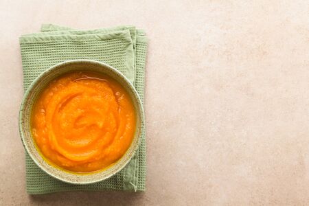 Fresh homemade pumpkin puree in bowl, photographed overhead with copy space on the right side (Selective Focus, Focus on the dish)の写真素材