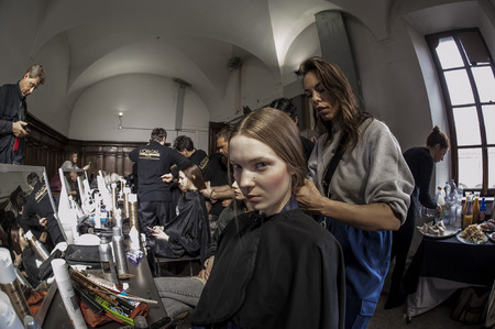 A model waits That Are arranged hair for the show in the backstage of Milan Shon during Milan Fashion Week 2015のeditorial素材